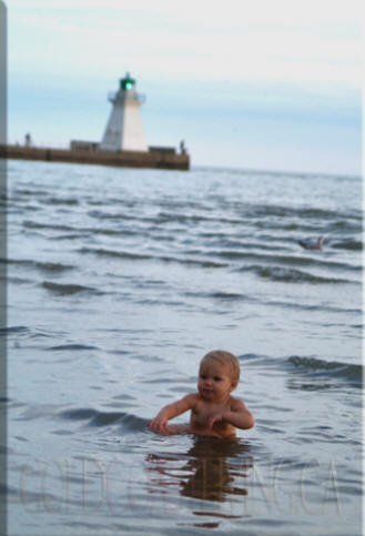 Photograph of baby in water at Port Dover beach, Norfolk County on Lake Erie, Ontario