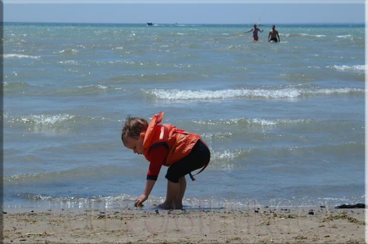 Photograph of toddler on Port Dover beach, Norfolk County on Lake Erie, Ontario